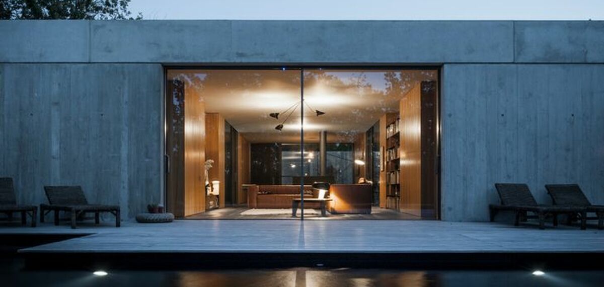 A yard view of the HiFinity Sliding System on a modern concrete house.